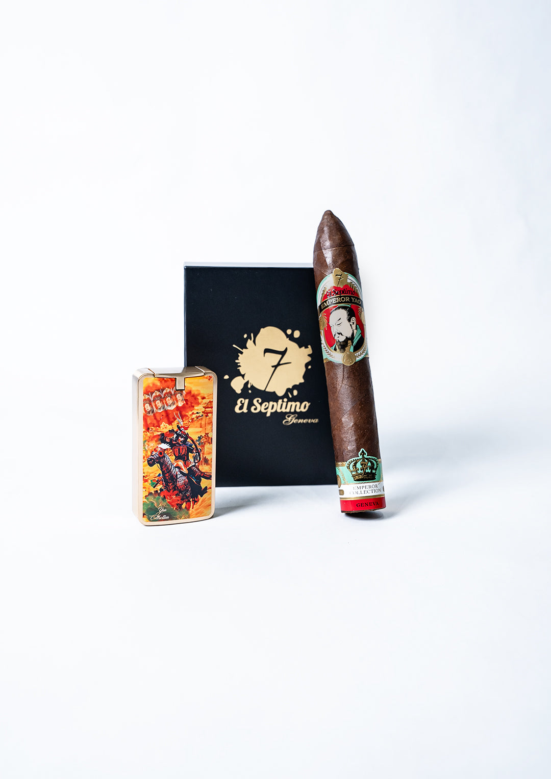 el septimo black cigar box with the words el septimo in gold letters. There is an actual cigar resting on the side of the box from the emperor yao collection and the cigar lighter from the same collection is in front of the box.