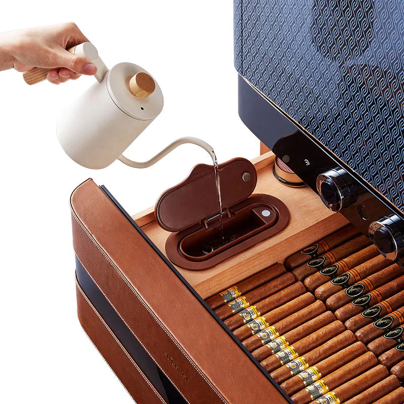 Pouring water into the reservoir of the humidor with large cigar storage