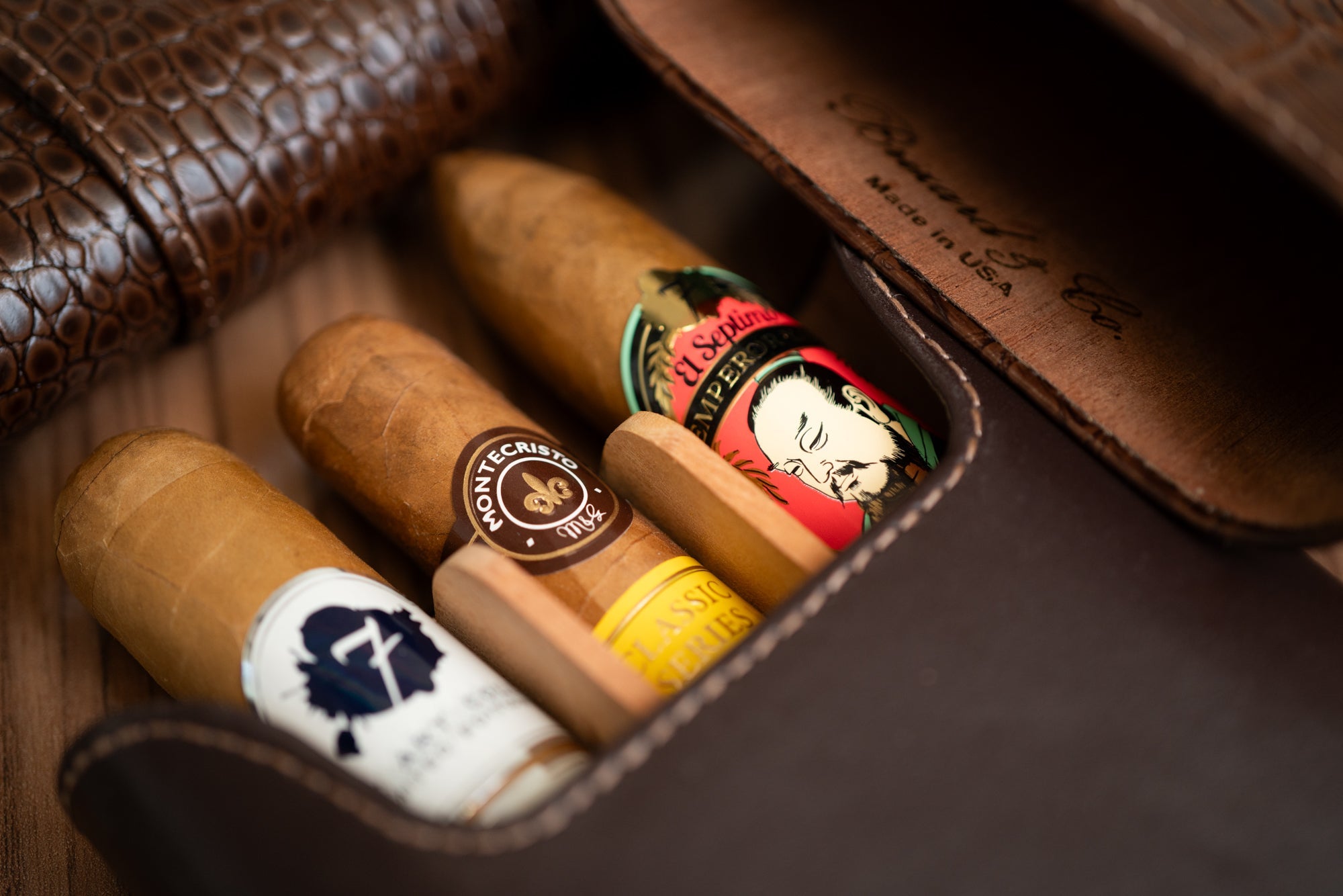 Three premium cigars in the Brizard and Co luxury traveling case. The cigars include El Septimo, Montecristo and El Septimo Emperor cigars