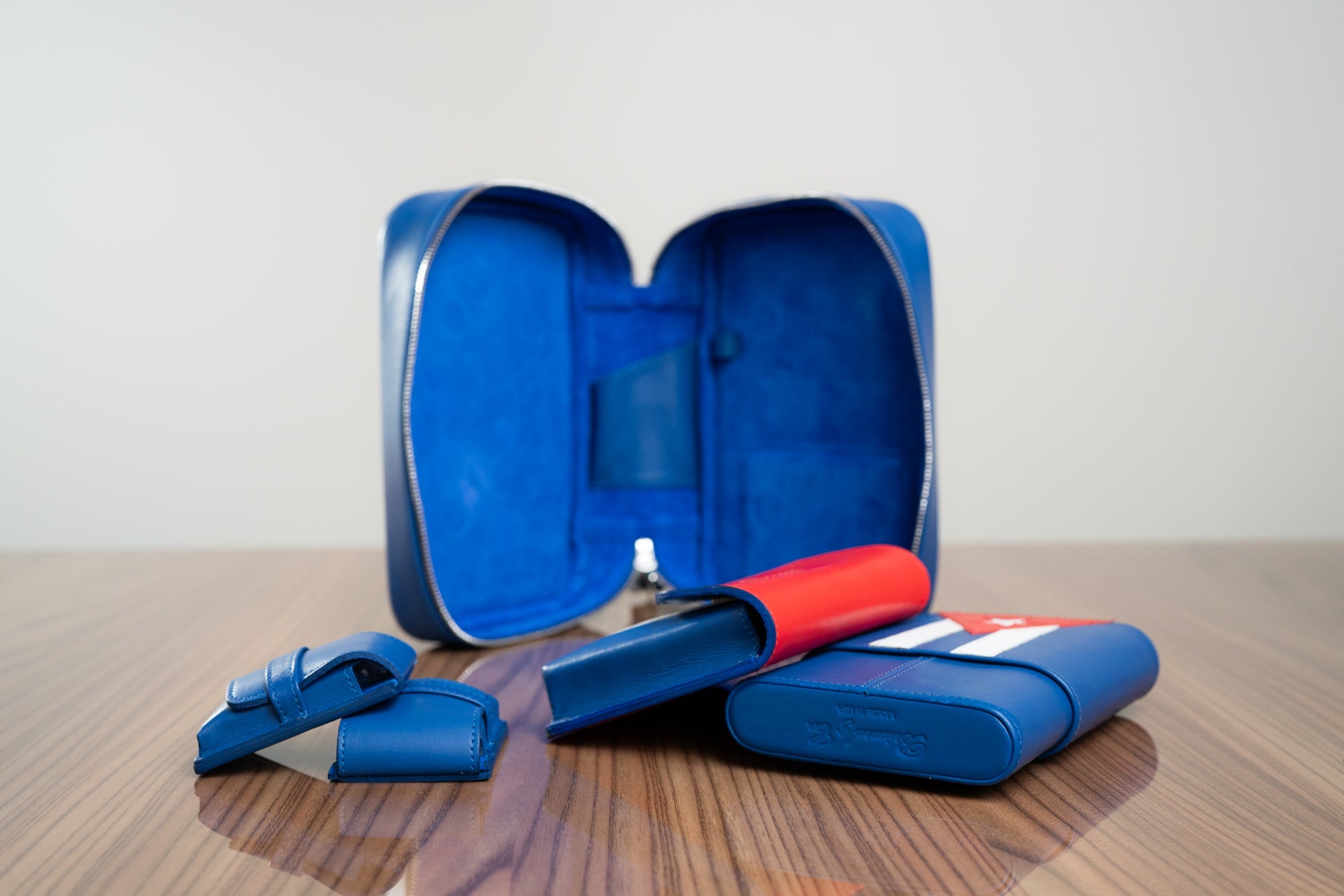 The Havana Traveler is the ultimate companion for the traveling cigar lover. Meticulously handcrafted from the finest top grain leather and lined with rich suede, this luxury accessory is designed to protect, organize, and elevate your cigar experience wherever you may go. Featuring the Cuban flag on all accessories.