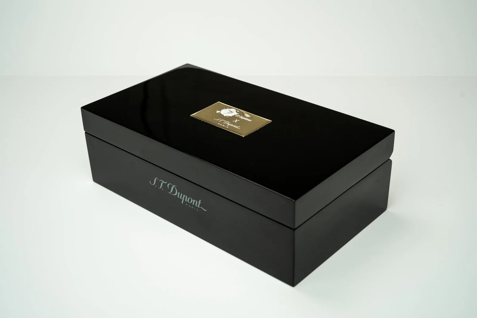 Black pen box with gold top and white letters