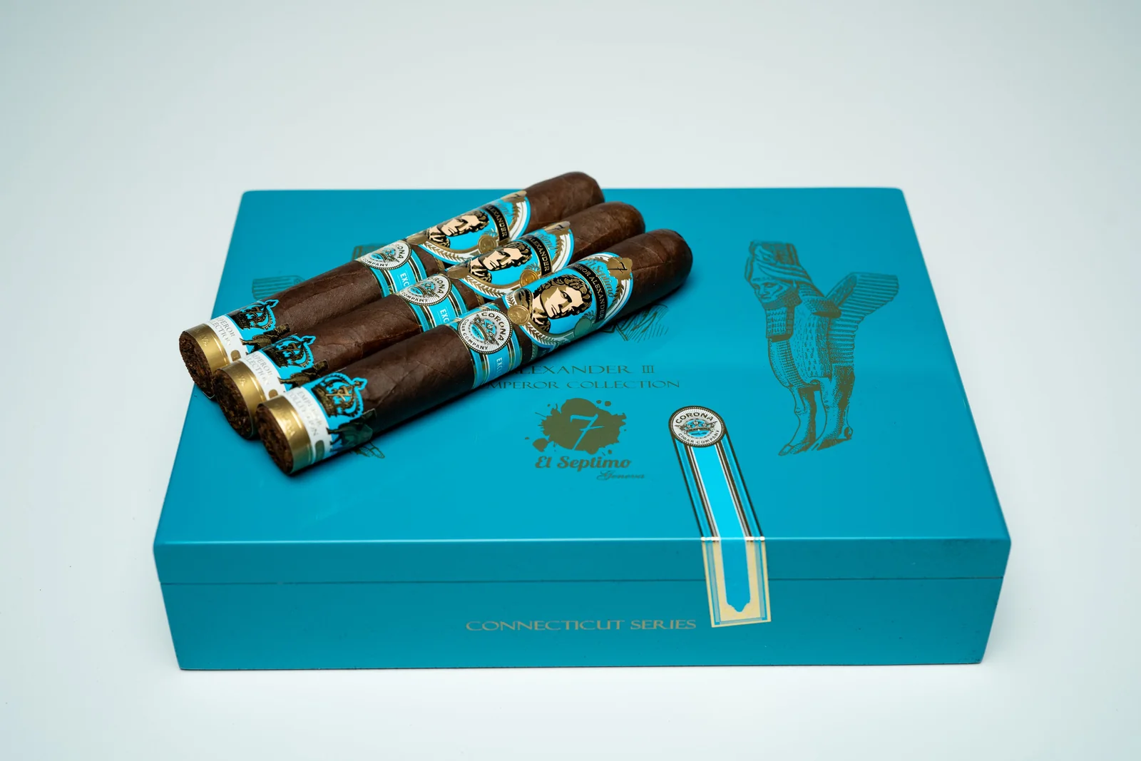 three premium cigars on a light blue and gold premium cigar box