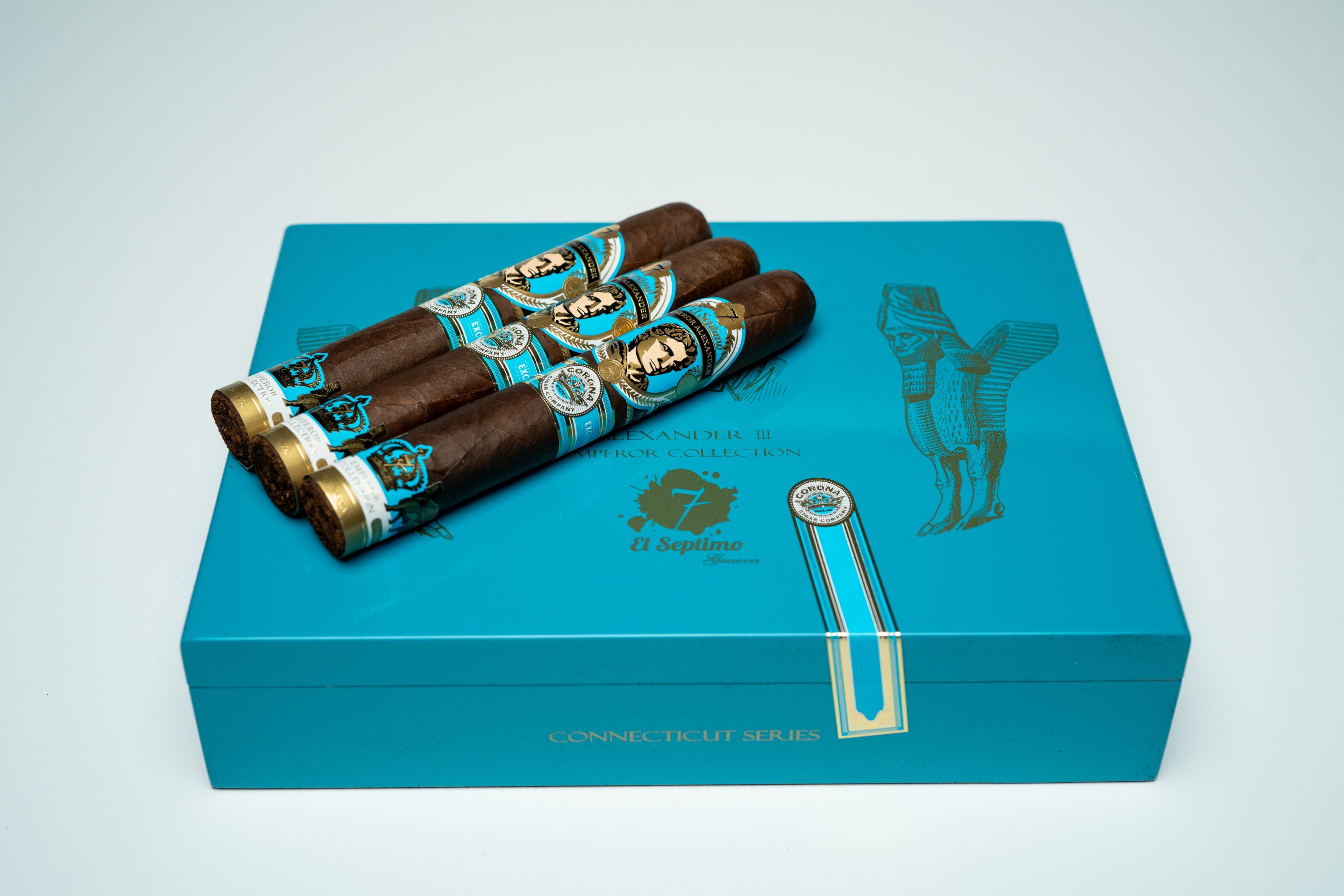 three premium cigars on a light blue and gold premium cigar box