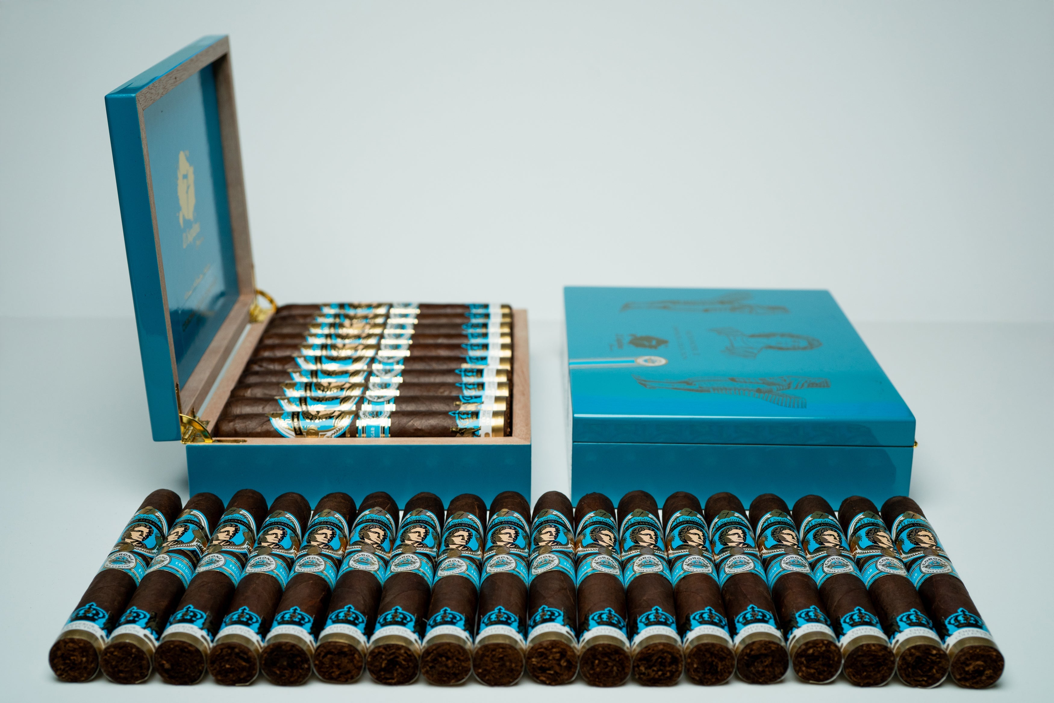 18 premium cigars with a blue, gold and black label with an image of emperor alexander on a light blue and gold premium cigar box