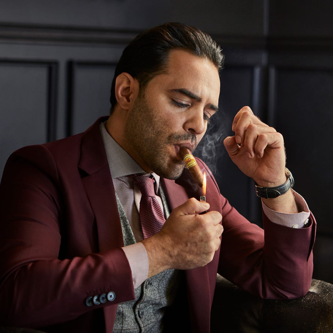man lighting a La Aurora Preferidos 1903 Gold Tubo – fine Corojo cigar from Los Angeles cigar shop