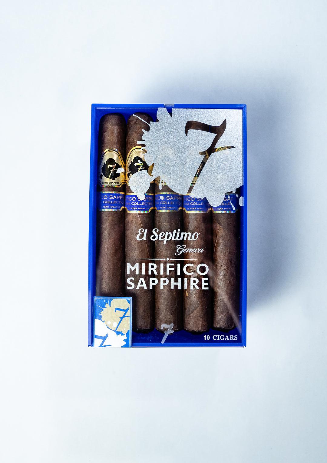 A box of Mirifico Sapphire El Septimo Cigars with purple and gold wrappers in a sapphire and white box with a clear front.